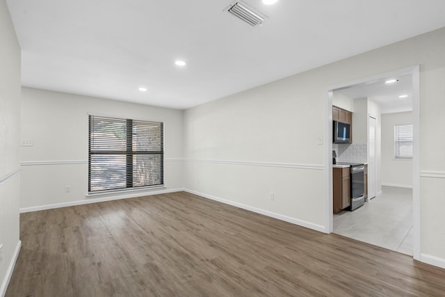 1828 Tracey Cir, Irving, TX 75060 - empty room featuring light wood-type flooring and recessed lighting