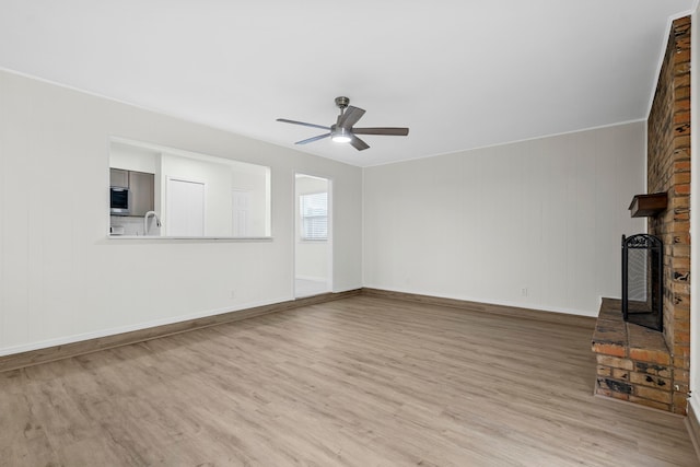 1828 Tracey Cir, Irving, TX 75060 - unfurnished living room featuring a fireplace, wood finished floors, and ceiling fan