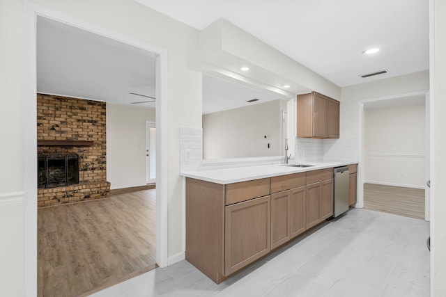 1828 Tracey Cir, Irving, TX 75060 - kitchen featuring stainless steel dishwasher, light countertops, decorative backsplash, a fireplace, and open floor plan