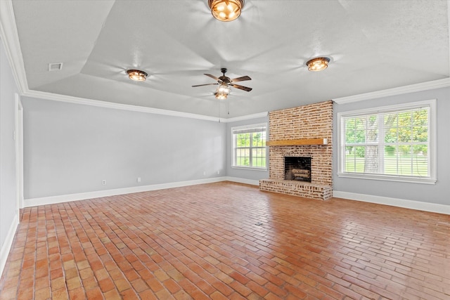 119 Locust Ct, Oak Leaf, TX 75154 - unfurnished living room with ornamental molding, ceiling fan, brick floors, a raised ceiling, and a brick fireplace