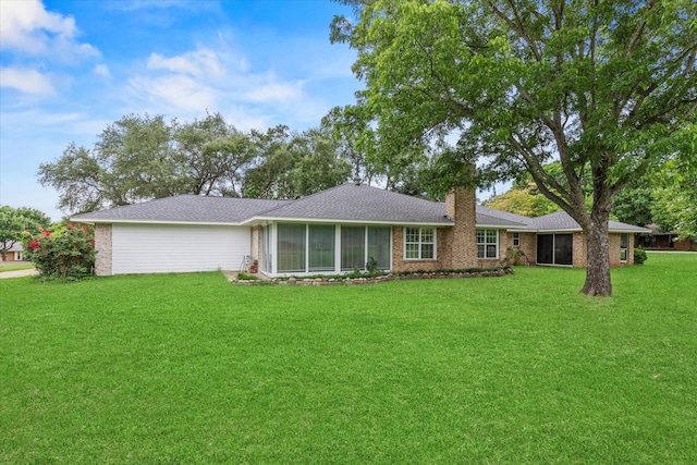 119 Locust Ct, Oak Leaf, TX 75154 - view of front of home featuring a sunroom, a chimney, a front yard, and brick siding