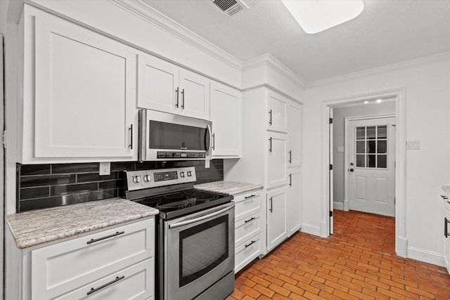 119 Locust Ct, Oak Leaf, TX 75154 - kitchen featuring stainless steel appliances, crown molding, brick patterned floors, white cabinetry, and backsplash