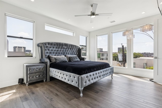 4726 Manett St Unit 101, Dallas, TX 75204 - bedroom with wood finished floors, recessed lighting, a ceiling fan, and a chandelier