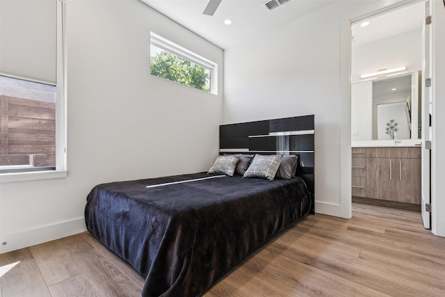 4726 Manett St Unit 101, Dallas, TX 75204 - bedroom with light wood-type flooring, ensuite bath, and recessed lighting
