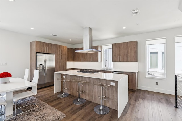 4726 Manett St Unit 101, Dallas, TX 75204 - kitchen featuring island range hood, appliances with stainless steel finishes, modern cabinets, a large island, and recessed lighting