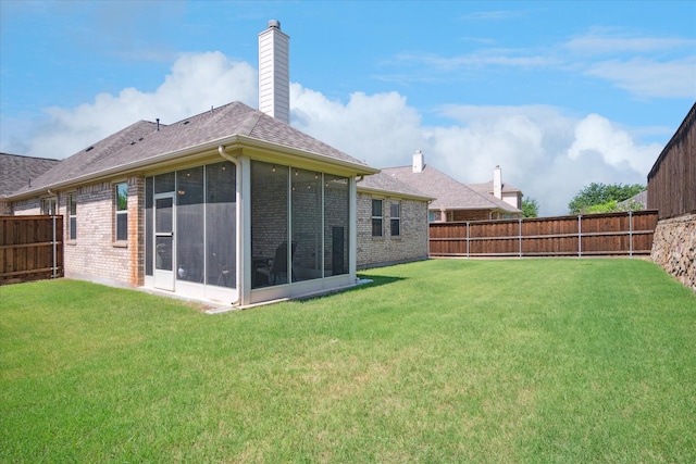 5704 Ridgeson Dr, Mckinney, TX 75071 - rear view of house with brick siding, a sunroom, a fenced backyard, and a chimney
