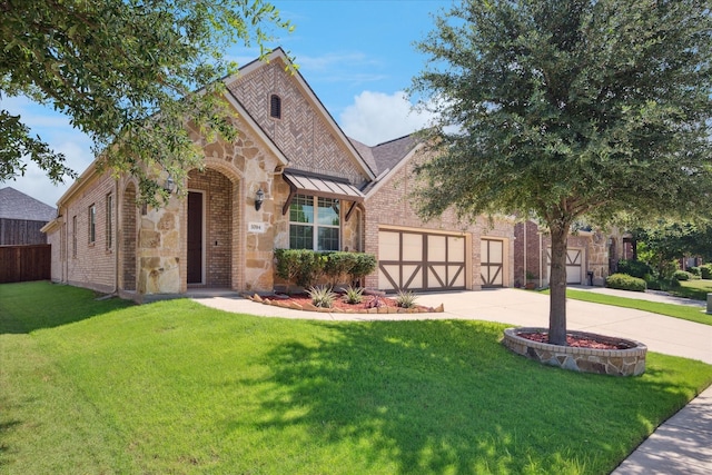 5704 Ridgeson Dr, Mckinney, TX 75071 - view of front of house featuring brick siding, driveway, a front yard, an attached garage, and stone siding