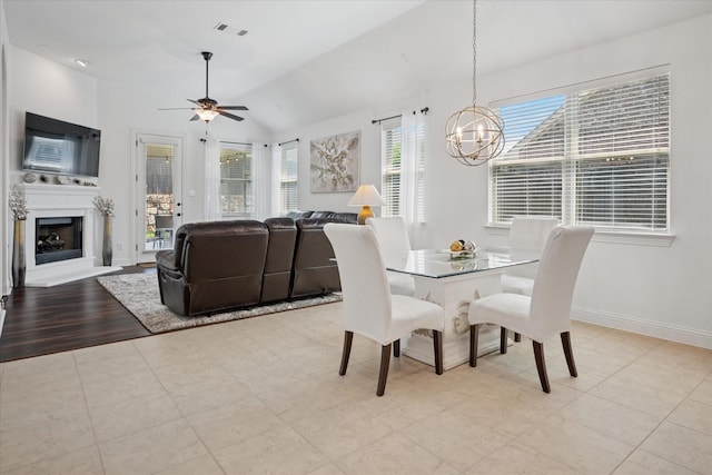 5704 Ridgeson Dr, Mckinney, TX 75071 - dining area with vaulted ceiling, a chandelier, ceiling fan, and a fireplace with raised hearth