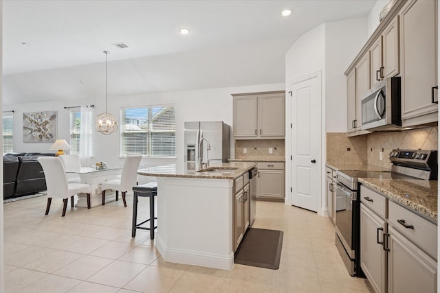 5704 Ridgeson Dr, Mckinney, TX 75071 - kitchen with appliances with stainless steel finishes, backsplash, light stone counters, an island with sink, and open floor plan