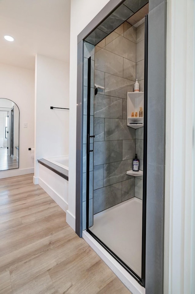 176 Private Road 33082, Sumner, TX 75486 - bathroom with a garden tub, wood finished floors, a shower stall, and recessed lighting