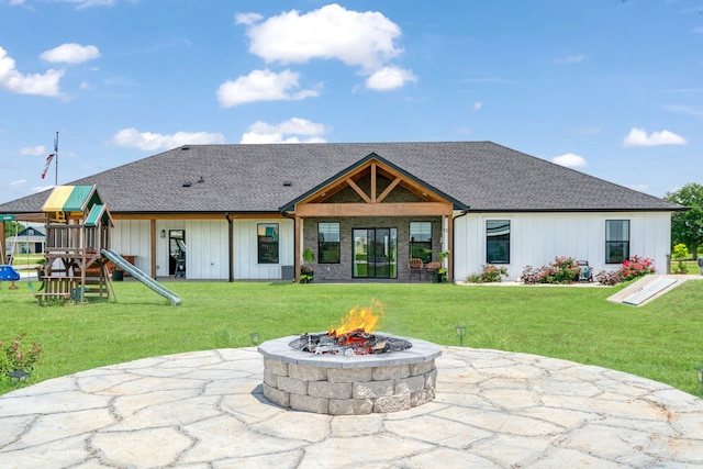 176 Private Road 33082, Sumner, TX 75486 - back of property with a fire pit, a playground, a yard, and board and batten siding