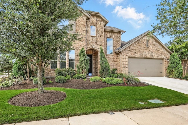 9920 Pikes Peak Pl, Little Elm, TX 75068 - view of front facade featuring an attached garage, driveway, a front yard, and brick siding