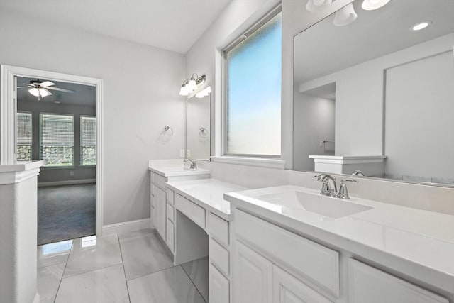 9920 Pikes Peak Pl, Little Elm, TX 75068 - bathroom with double vanity, marble finish flooring, and ceiling fan