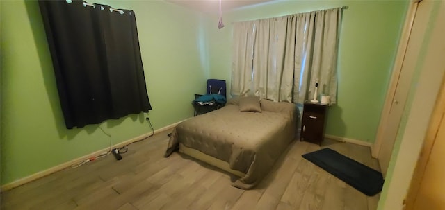 605 N Davis Dr, Arlington, TX 76012 - bedroom featuring baseboards and wood finished floors