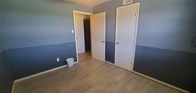 605 N Davis Dr, Arlington, TX 76012 - unfurnished bedroom featuring wood finished floors