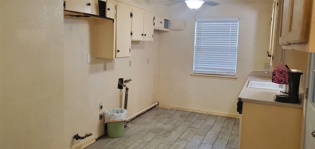 605 N Davis Dr, Arlington, TX 76012 - laundry room featuring a ceiling fan, light wood-style flooring, and healthy amount of natural light