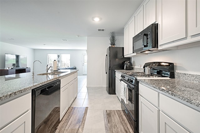 1773 Courage Crk, Crandall, TX 75114 - kitchen with black appliances, stone countertops, open floor plan, white cabinetry, and recessed lighting