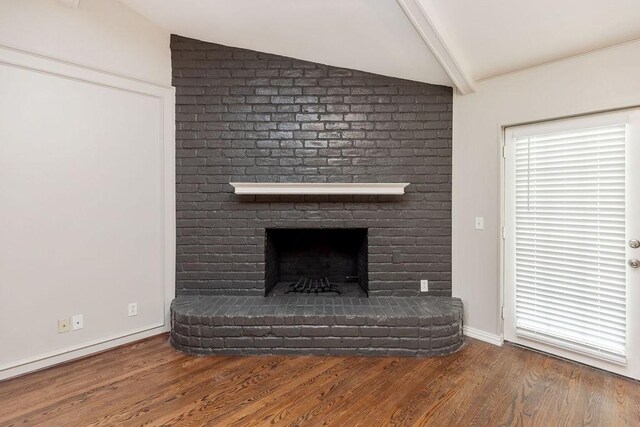 3101 Bonniebrook Dr, Plano, TX 75075 - unfurnished living room with wood finished floors and a brick fireplace