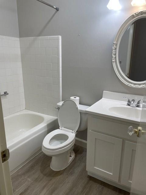 56 E Mountain Creek Dr Unit 22, Grand Prairie, TX 75052 - full bathroom featuring wood finished floors and vanity