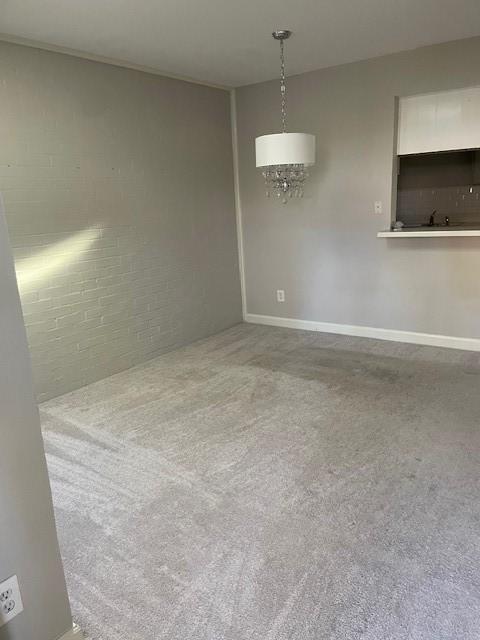 56 E Mountain Creek Dr Unit 22, Grand Prairie, TX 75052 - spare room with carpet floors and a chandelier