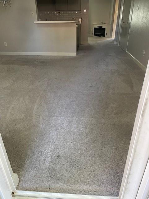 56 E Mountain Creek Dr Unit 22, Grand Prairie, TX 75052 - unfurnished living room with carpet and baseboards