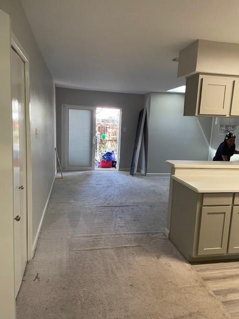 56 E Mountain Creek Dr Unit 22, Grand Prairie, TX 75052 - hallway featuring light colored carpet and baseboards