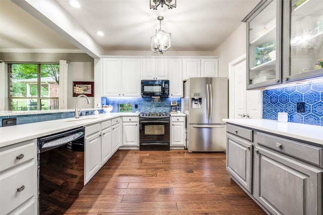 1506 Pine Hills Ln, Corinth, TX 76210 - kitchen featuring black appliances, light countertops, decorative backsplash, a chandelier, and glass insert cabinets