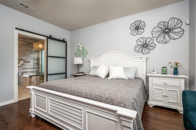 1506 Pine Hills Ln, Corinth, TX 76210 - bedroom with dark wood-style floors, a barn door, and connected bathroom