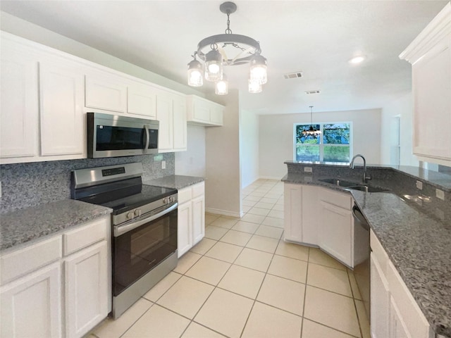 6231 Bridle Trl, Caddo Mills, TX 75135 - kitchen featuring appliances with stainless steel finishes, a chandelier, tasteful backsplash, white cabinetry, and stone countertops