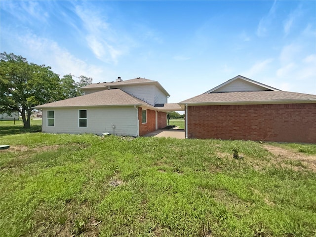 6231 Bridle Trl, Caddo Mills, TX 75135 - back of property featuring brick siding, a lawn, and a shingled roof