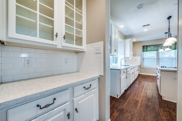 6001 Autumn Way, Mckinney, TX 75072 - kitchen with dark wood finished floors, glass insert cabinets, white cabinets, and decorative backsplash