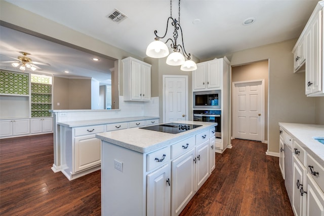 6001 Autumn Way, Mckinney, TX 75072 - kitchen with appliances with stainless steel finishes, a kitchen island, dark wood-style floors, white cabinets, and recessed lighting