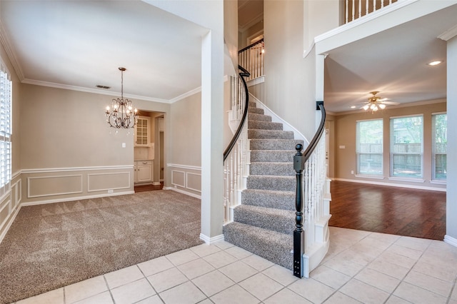 6001 Autumn Way, Mckinney, TX 75072 - staircase with a chandelier, crown molding, ceiling fan, a decorative wall, and tile patterned floors