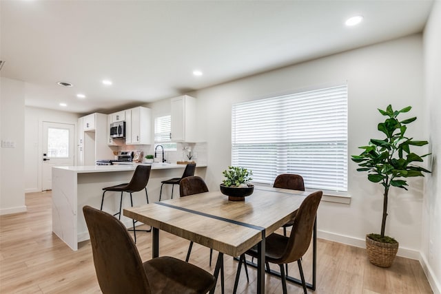 826 Nash St, Rockwall, TX 75087 - dining room with light wood finished floors and recessed lighting