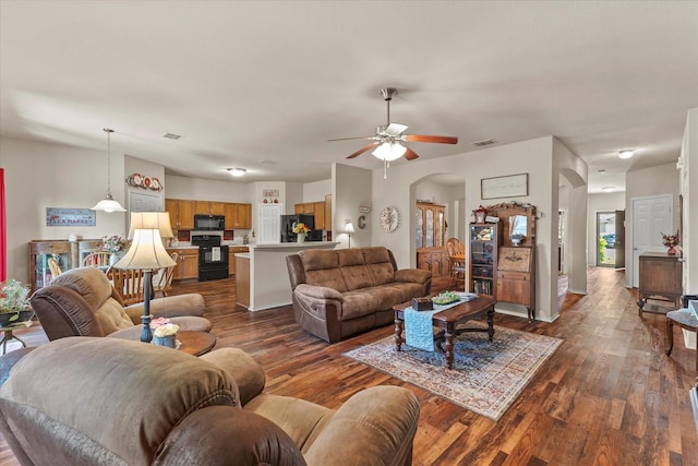 118 Independence Trl, Forney, TX 75126 - living area with arched walkways, a ceiling fan, and dark wood-type flooring