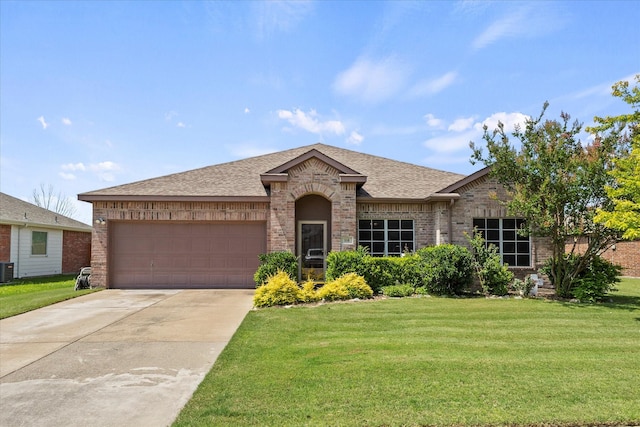 118 Independence Trl, Forney, TX 75126 - view of front facade featuring a front yard, brick siding, a garage, driveway, and roof with shingles