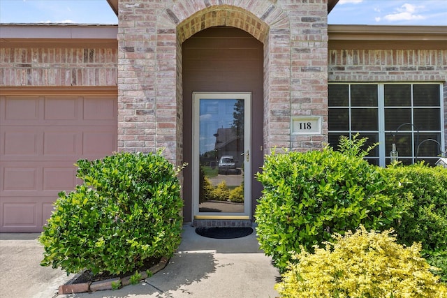118 Independence Trl, Forney, TX 75126 - view of exterior entry featuring an attached garage and brick siding