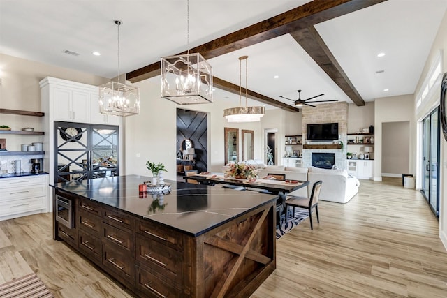 12965 Torello Ct, Godley, TX 76044 - kitchen with beam ceiling, dark countertops, ceiling fan, white cabinets, and open shelves