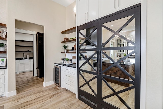 12965 Torello Ct, Godley, TX 76044 - wine area with beverage cooler, bar, and light wood-style floors
