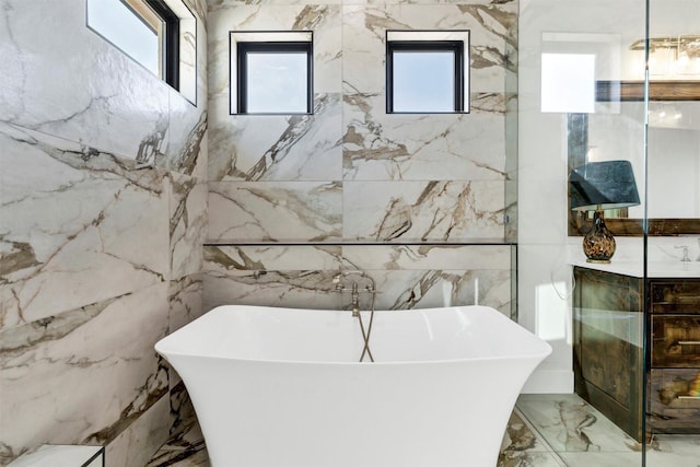 12965 Torello Ct, Godley, TX 76044 - full bathroom featuring marble tiled floors, a freestanding bath, and vanity