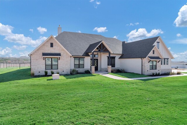 12965 Torello Ct, Godley, TX 76044 - view of front facade with board and batten siding, a chimney, a shingled roof, and stone siding