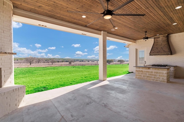 12965 Torello Ct, Godley, TX 76044 - view of patio featuring ceiling fan, a rural view, and exterior kitchen