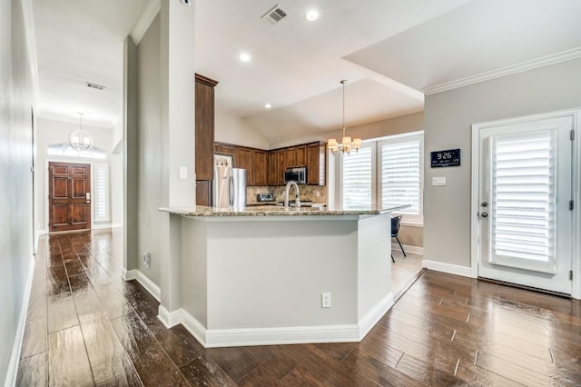 114 Stonecreek Dr, Irving, TX 75063 - kitchen with a chandelier, stainless steel appliances, light stone countertops, dark wood finished floors, and pendant lighting