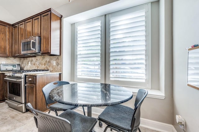 114 Stonecreek Dr, Irving, TX 75063 - kitchen with stainless steel appliances, decorative backsplash, light countertops, and light tile patterned floors