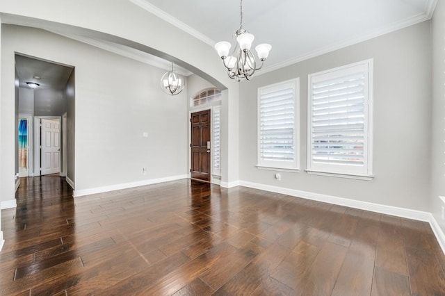 114 Stonecreek Dr, Irving, TX 75063 - empty room with a chandelier, dark wood finished floors, arched walkways, and ornamental molding