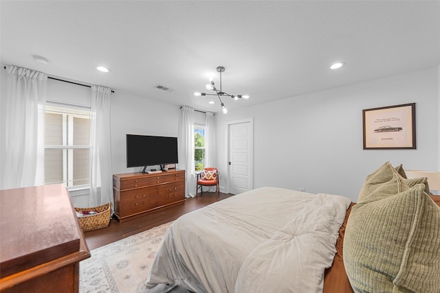 2340 Starks Ave, Dallas, TX 75215 - bedroom featuring dark wood-style flooring, a chandelier, and recessed lighting