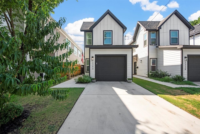 2340 Starks Ave, Dallas, TX 75215 - view of front of house with board and batten siding, a garage, and concrete driveway