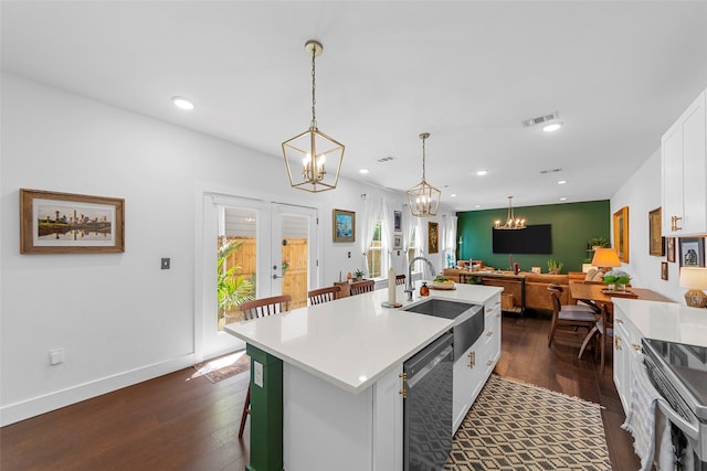 2340 Starks Ave, Dallas, TX 75215 - kitchen with a chandelier, dark wood finished floors, white cabinetry, light countertops, and recessed lighting