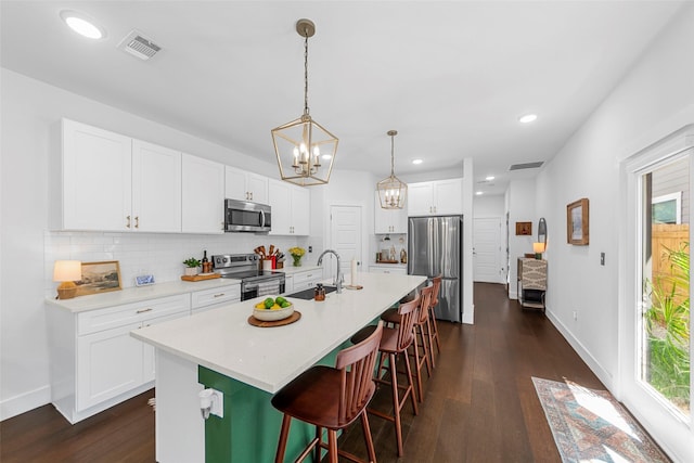 2340 Starks Ave, Dallas, TX 75215 - kitchen with stainless steel appliances, a chandelier, dark wood-style flooring, backsplash, and recessed lighting