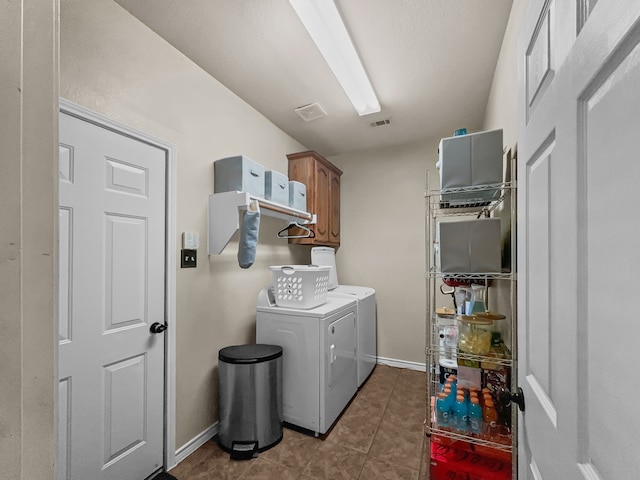 8600 La Quinta Ln, Mckinney, TX 75070 - laundry area featuring cabinet space, washing machine and dryer, and dark tile patterned flooring